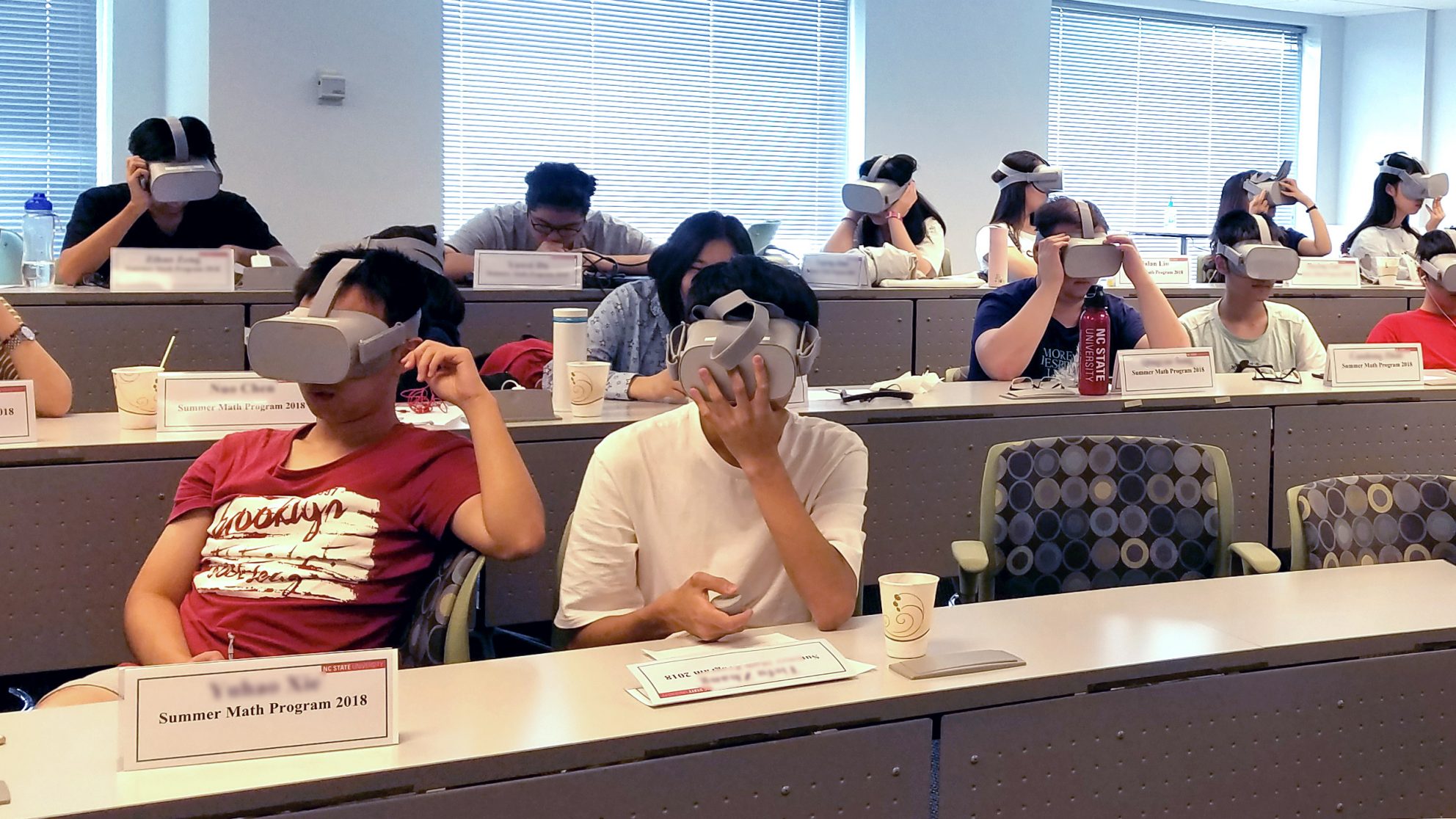 A classroom of students completing the module with VR headsets.