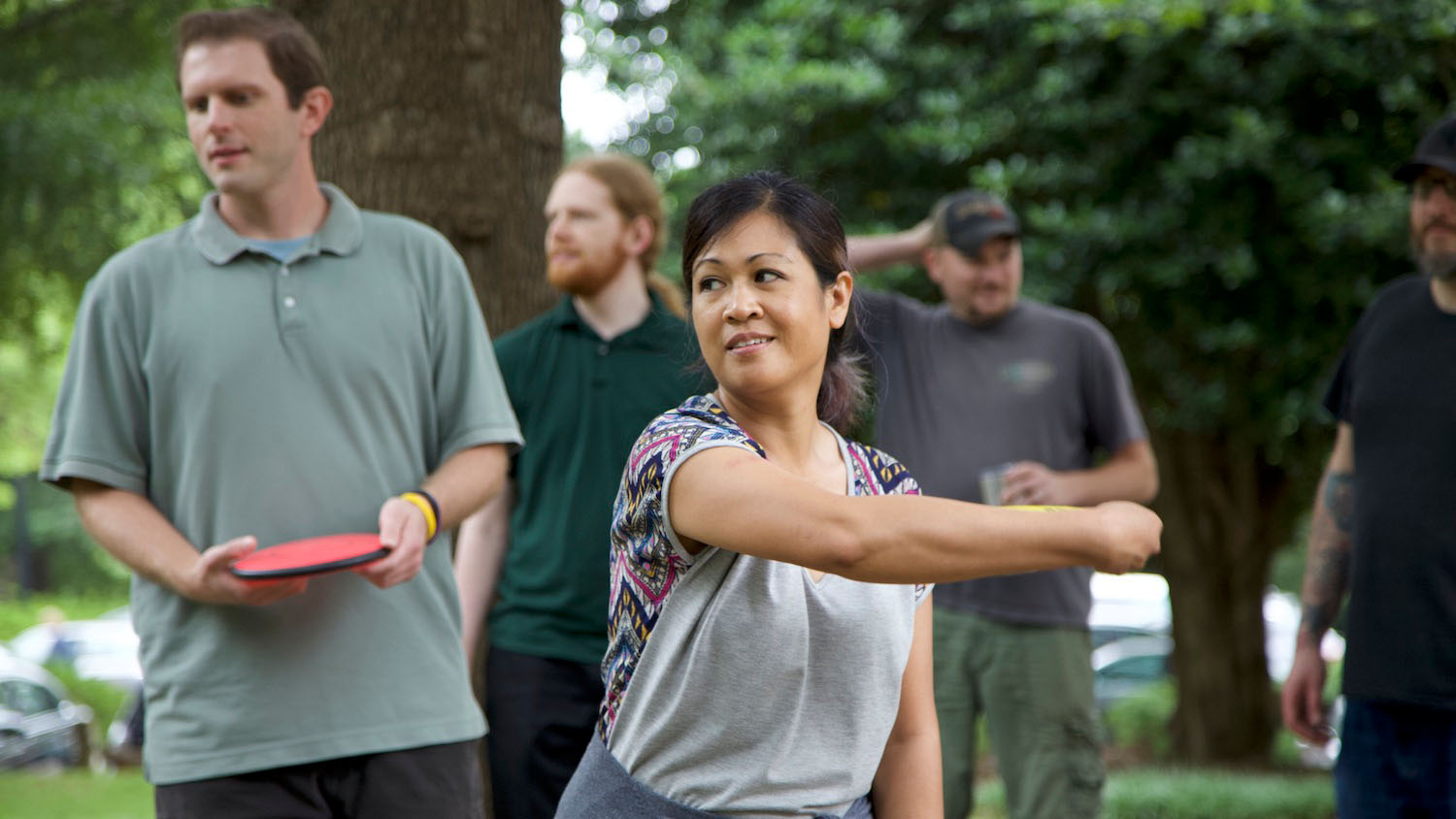 Arlene Mendoza-Moran and colleagues playing frisbee outside.