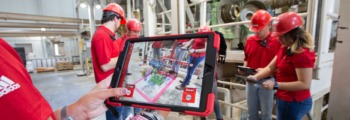 An immersive feed mill experience is displayed on an iPad