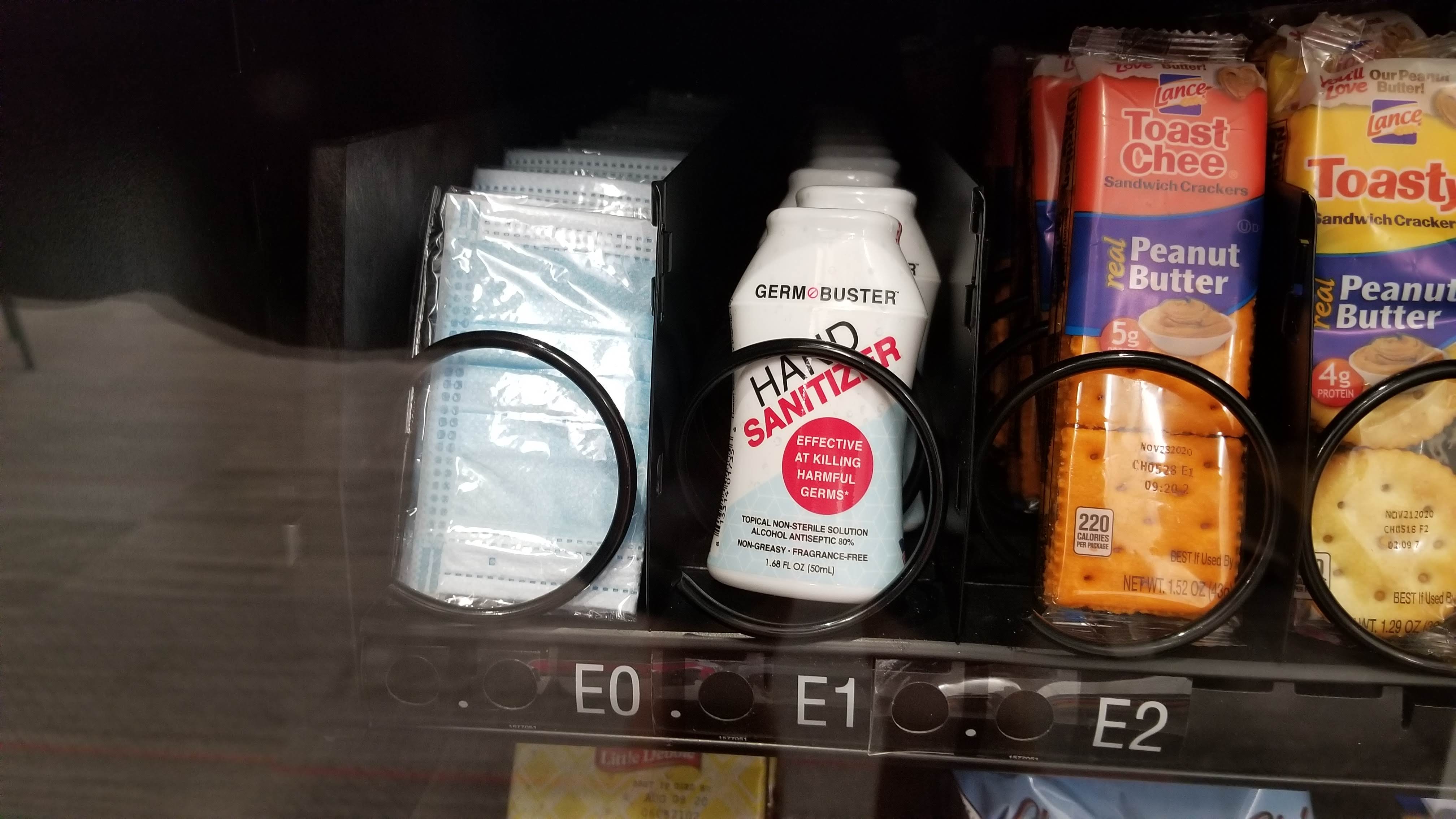 Vending machine during COVID, complete with masks and hand sanitizer.