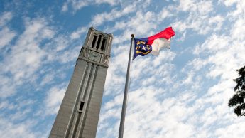NC State Belltower and flag of North Carolina