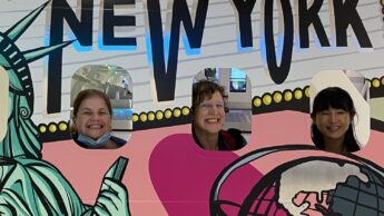 people posed in New York head cutouts