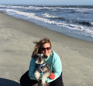 Photo of Suzanne Edmonds and her dog at the beach