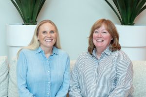 Julianne Treme (left) and Christine Cranford (right) are serving as faculty leads. Julianne and Christine are sitting together on the couch in the CTI lobby. 