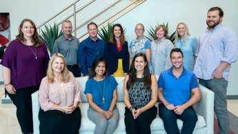 The fall 2019 OCIP team and faculty cohort. Front row, left to right: Rebecca Sanchez, Arlene Mendoza-Moran, Bethanne Tobey, Christopher Beeson. Standing, left to right: Bethany Smith, Michael Kanters, Seth Murray, Wendy Warner, Melissa Hendrickson, Christine Cranford, Julianne Treme, Vince Lastreto. Not pictured: Jamie Larsen. Photo by Katie Harris. The front row is sitting on the couch in the CTI lobby and the back row is standing behind them.