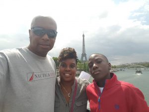 Robinson with his wife, Tameka, and son, Austin, at the Eiffel Tower in Paris, France.