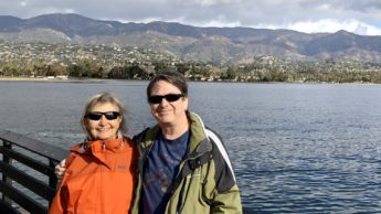 Scott and his aunt pose in front of water and hills in Santa Barbara, California.
