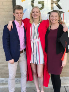 Petherbridge poses with her son and daughter. Her daughter wears a graduation gown.
