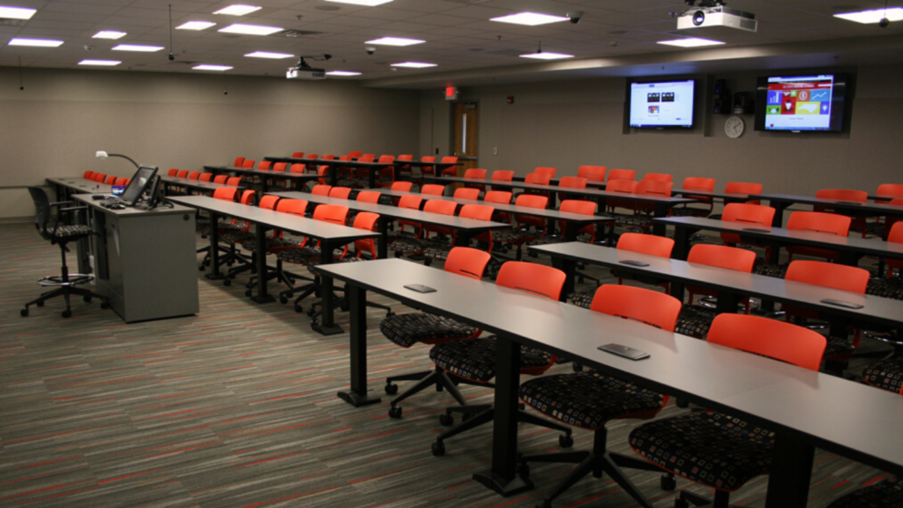 DELTA Classroom with red rows of seats and a computer podium.