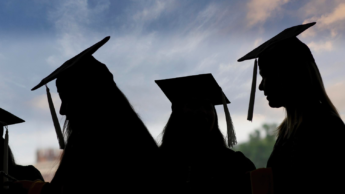 Silhouette of graduates wearing their caps