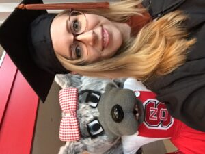 DiMattina snaps a picture with Ms. Wuf at her commencement.