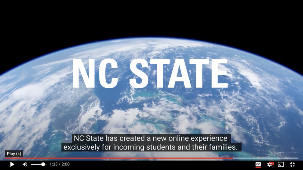 This is an example of closed captioning taken from the Wicked Problems Wolfpack Solutions informational video. The NC State logo is featured in the the night sky above the image of Earth with closed captions at the bottom of the screen.