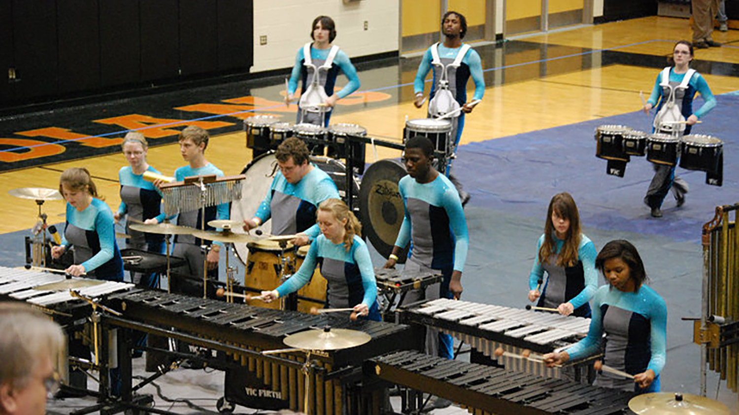 Picture of Katie (center front row) performing in the marching ensemble playing the marimba