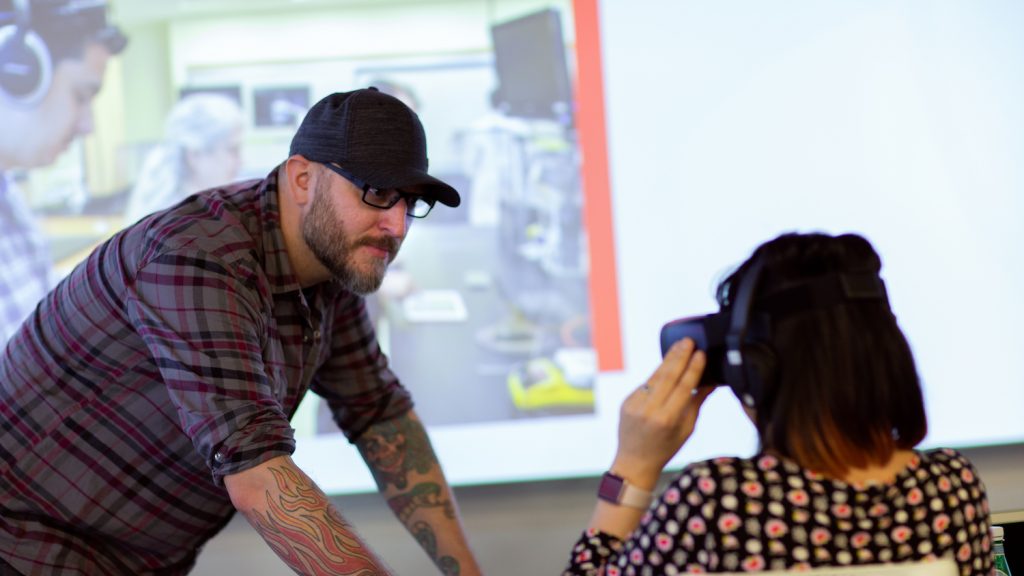 DELTA staff assists guest with VR station