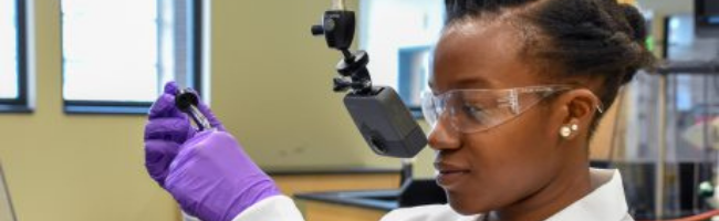 Teaching Assistant Lyniesha Wright during a test shoot of the organic chemistry virtual reality labs. The placement of the GoPro Fusion 360° camera gives the experience a first-person point of view.