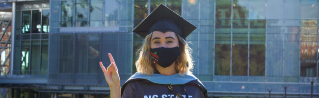 Graduate in a mask on NC State campus.