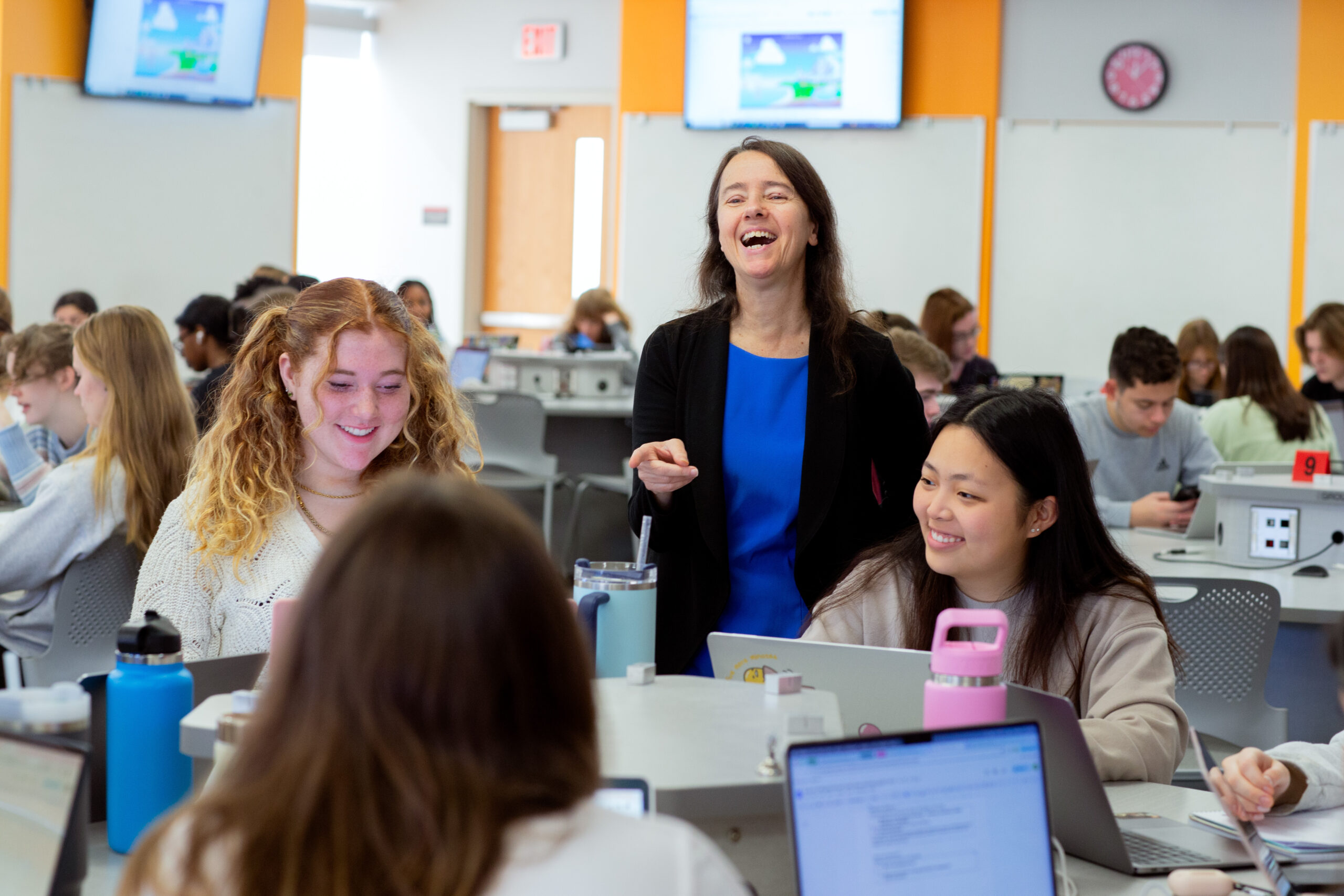 teacher instructing students in classroom
