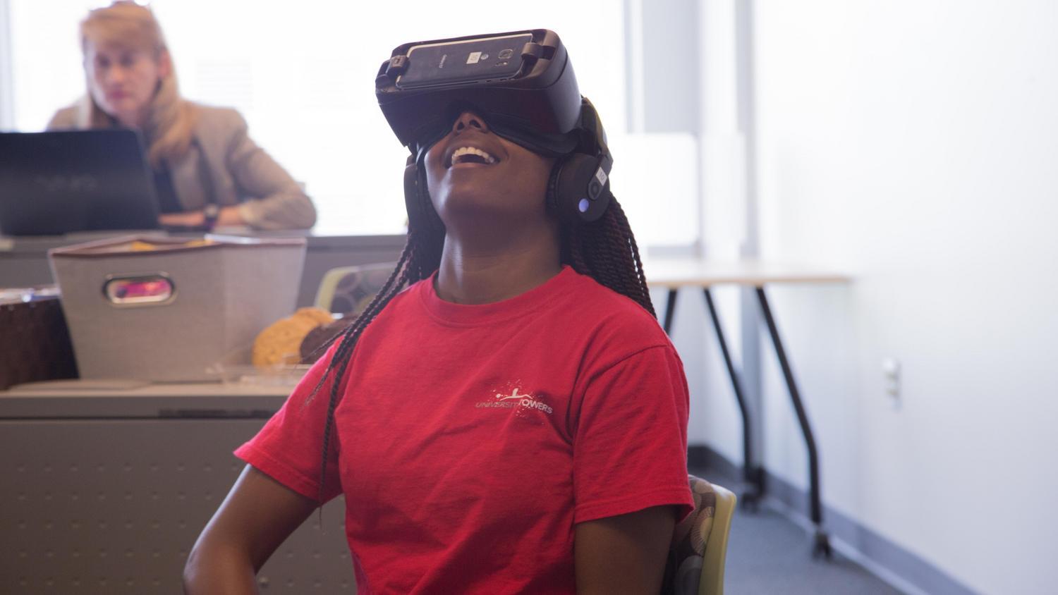 girl looking through a virtual reality headset